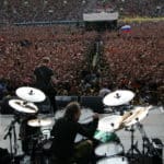 Band playing in front of a large crowd at an event